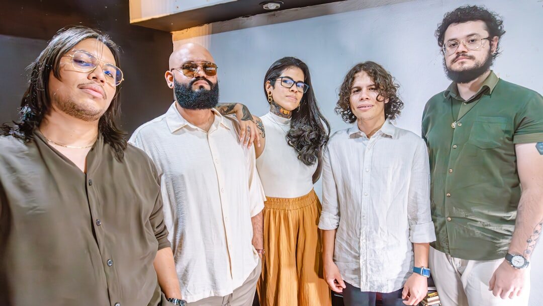 Diverse group of four colleagues smiling together in a studio