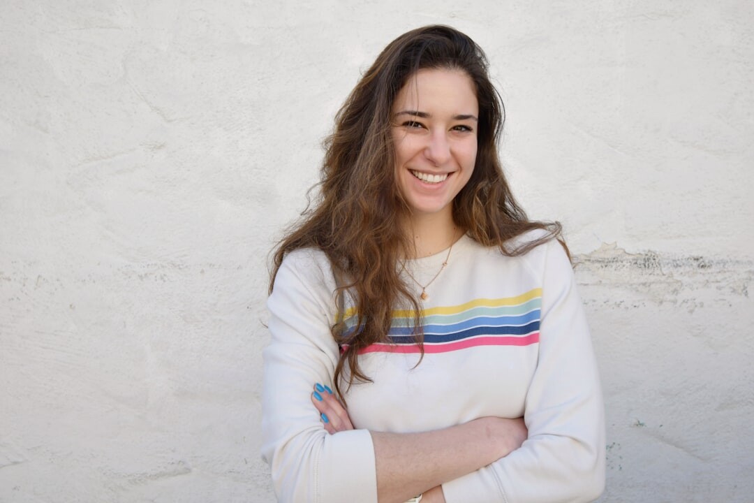 Woman fashion editor standing with arms crossed smiling